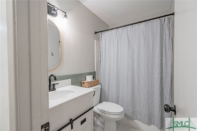 bathroom with tile patterned floors, vanity, and toilet