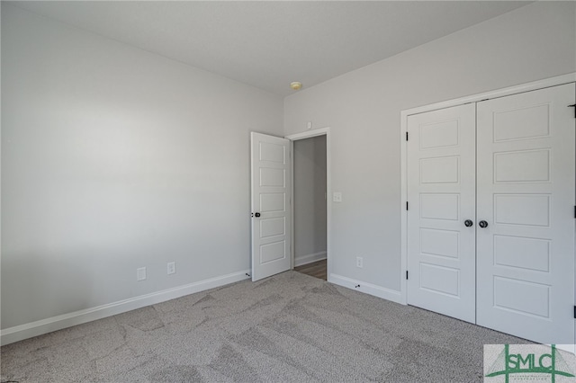 unfurnished bedroom with a closet and carpet floors