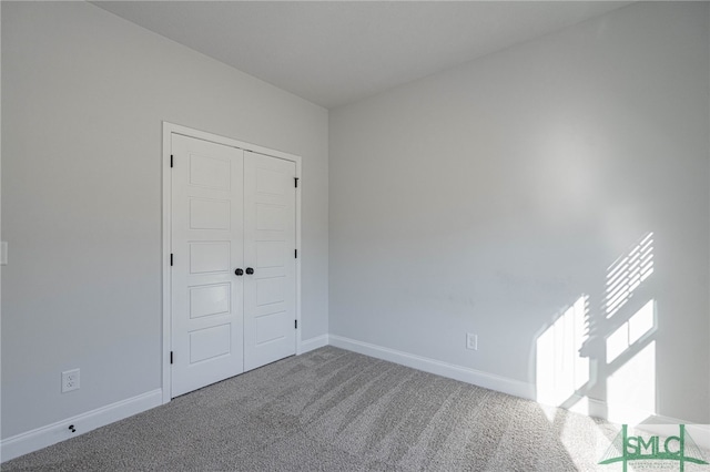 unfurnished bedroom with carpet and a closet