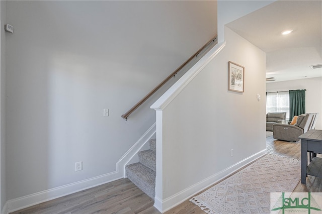 stairway with hardwood / wood-style flooring