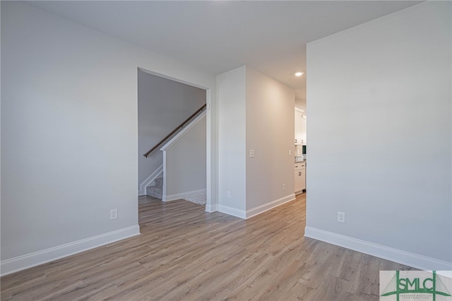 spare room with light hardwood / wood-style flooring