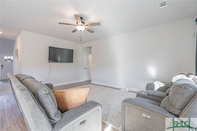 living room with light wood-type flooring and ceiling fan