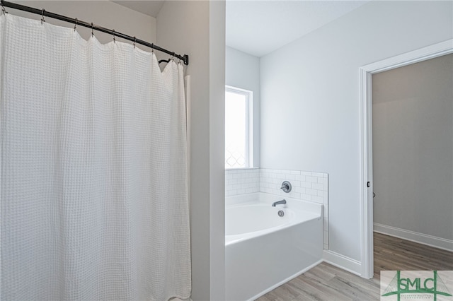 bathroom with independent shower and bath and wood-type flooring