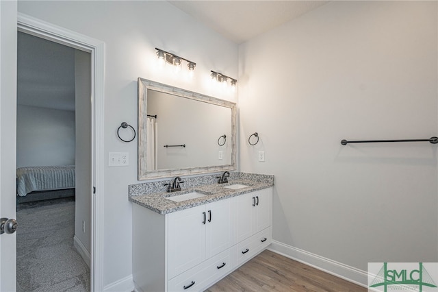 bathroom with vanity and hardwood / wood-style flooring