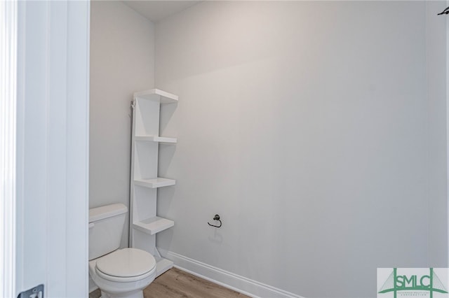 bathroom featuring toilet and hardwood / wood-style flooring