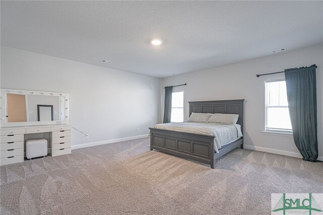 carpeted bedroom featuring a textured ceiling