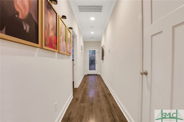 hallway with crown molding and dark wood-type flooring