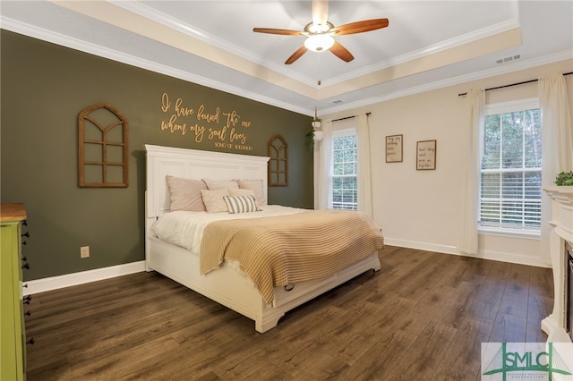 bedroom with ornamental molding, multiple windows, dark wood-type flooring, and ceiling fan