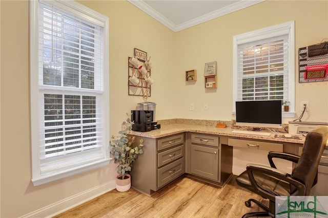 home office featuring crown molding, built in desk, and light wood-type flooring