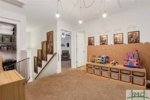 playroom featuring ceiling fan and carpet floors