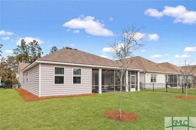 back of house with a sunroom and a lawn