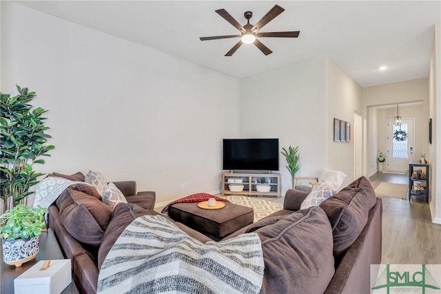 living room with hardwood / wood-style floors and ceiling fan