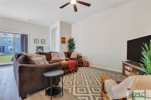 living room featuring ceiling fan and light hardwood / wood-style floors