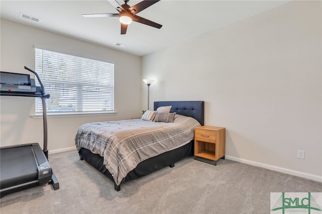 bedroom with ceiling fan and light colored carpet