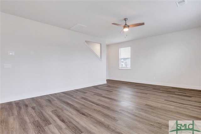 empty room featuring hardwood / wood-style floors and ceiling fan