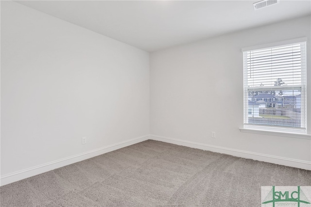 unfurnished room with carpet flooring and plenty of natural light