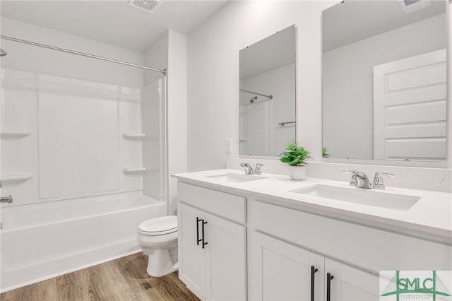 full bathroom featuring vanity, hardwood / wood-style flooring, toilet, and tub / shower combination