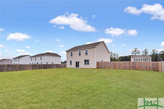 rear view of house with a lawn