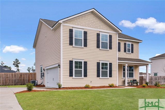 view of front of house featuring central AC, a garage, and a front lawn