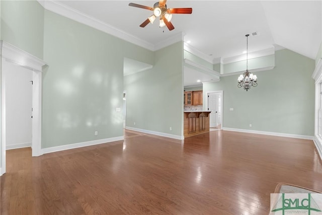 unfurnished living room featuring high vaulted ceiling, ornamental molding, ceiling fan with notable chandelier, wood finished floors, and baseboards