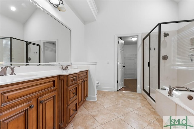 bathroom with tile patterned flooring, a shower stall, a garden tub, double vanity, and a sink