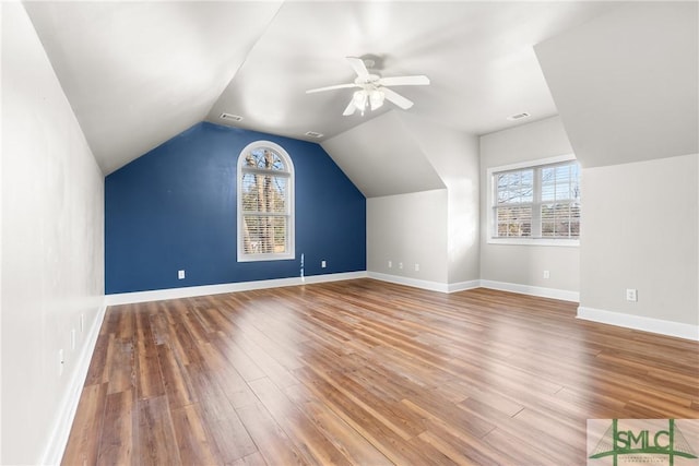 bonus room with visible vents, baseboards, lofted ceiling, and wood finished floors