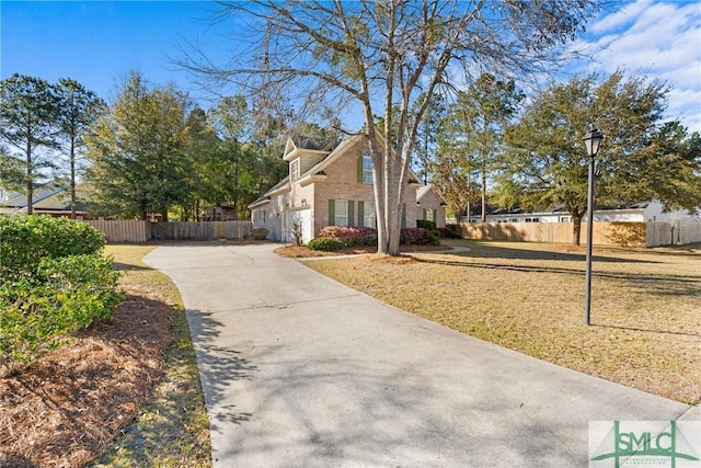 view of property exterior with a lawn, driveway, and fence