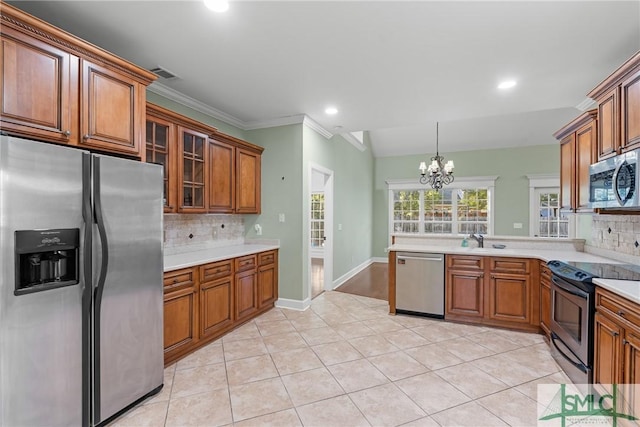 kitchen featuring visible vents, brown cabinets, a sink, stainless steel appliances, and light countertops