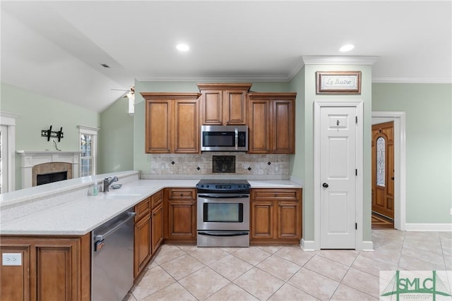 kitchen featuring a sink, stainless steel appliances, and brown cabinets