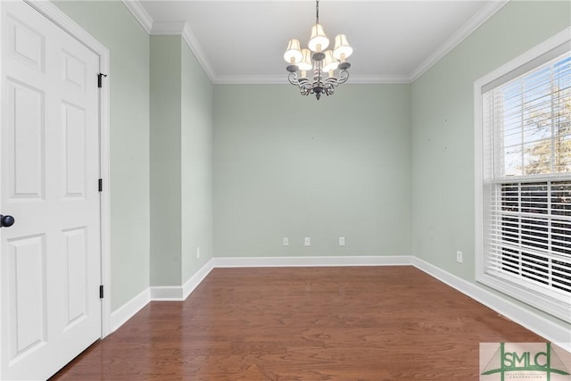 spare room with baseboards, wood finished floors, a chandelier, and ornamental molding