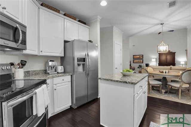 kitchen with appliances with stainless steel finishes, dark hardwood / wood-style floors, and white cabinetry