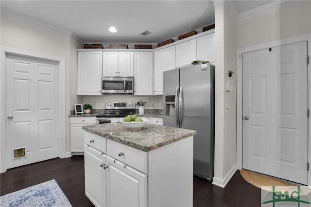 kitchen featuring dark hardwood / wood-style floors, a kitchen island, white cabinetry, and appliances with stainless steel finishes