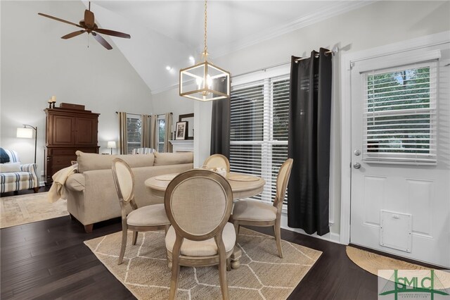 dining space with ceiling fan with notable chandelier, dark hardwood / wood-style flooring, high vaulted ceiling, and ornamental molding