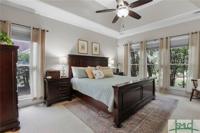 bedroom featuring ceiling fan, crown molding, light carpet, and multiple windows