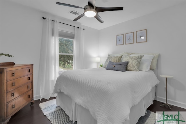 bedroom with ceiling fan and dark hardwood / wood-style floors