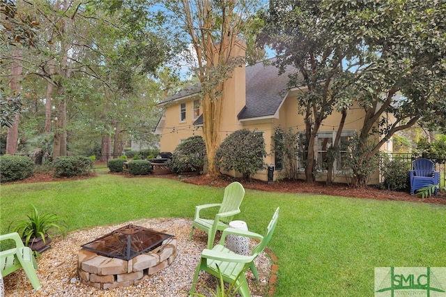 view of yard with a fire pit