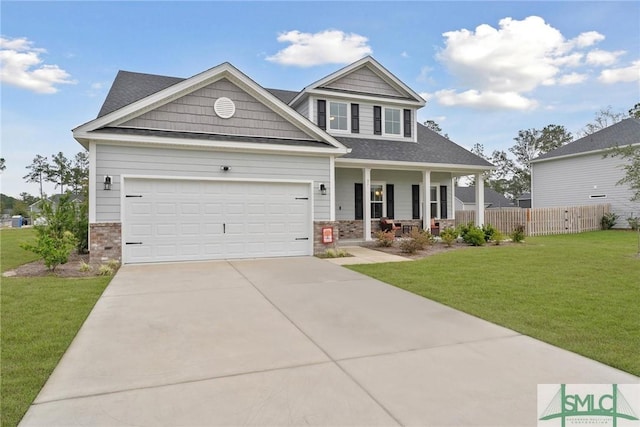 craftsman-style house with a garage, covered porch, and a front yard