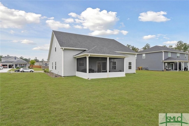 back of property featuring a sunroom and a lawn