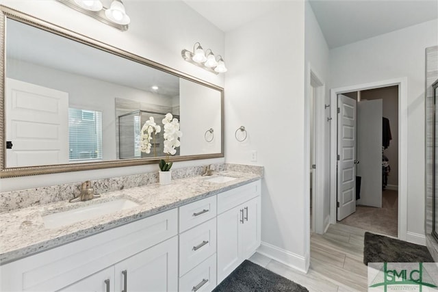 bathroom featuring vanity and a shower with shower door