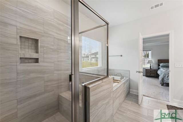 bathroom with tile patterned floors and separate shower and tub