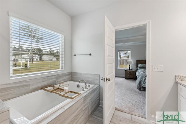 bathroom with vanity, tile patterned floors, and tiled tub