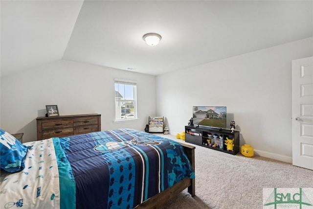 carpeted bedroom with lofted ceiling