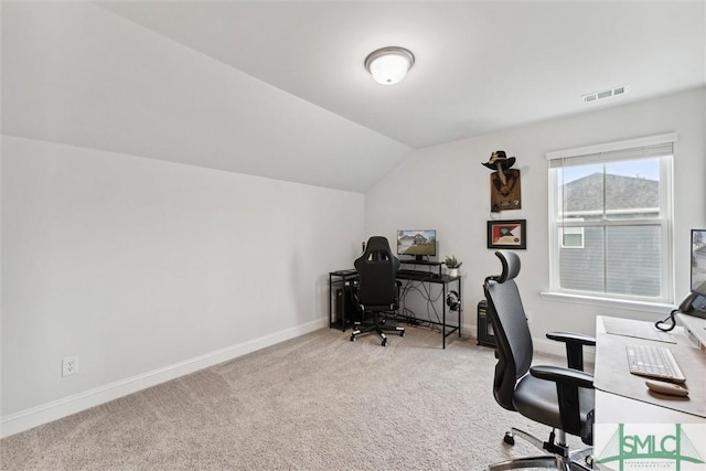 carpeted home office featuring lofted ceiling