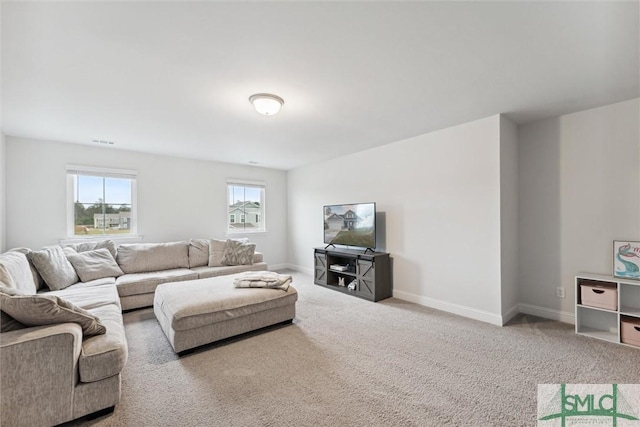 living room with light carpet and a healthy amount of sunlight