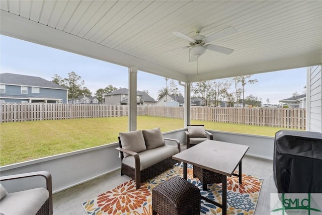 sunroom featuring ceiling fan