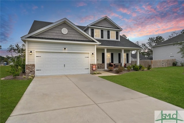 craftsman-style house featuring a porch, a yard, and a garage