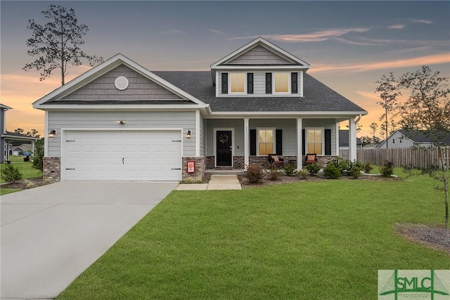 craftsman inspired home featuring a porch, a garage, and a yard