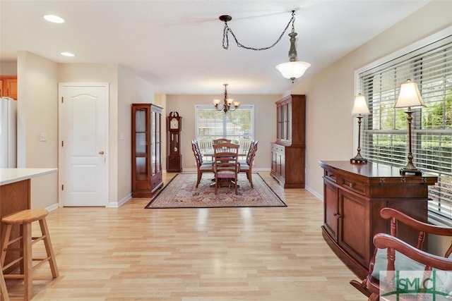 dining area with a notable chandelier and light wood-type flooring