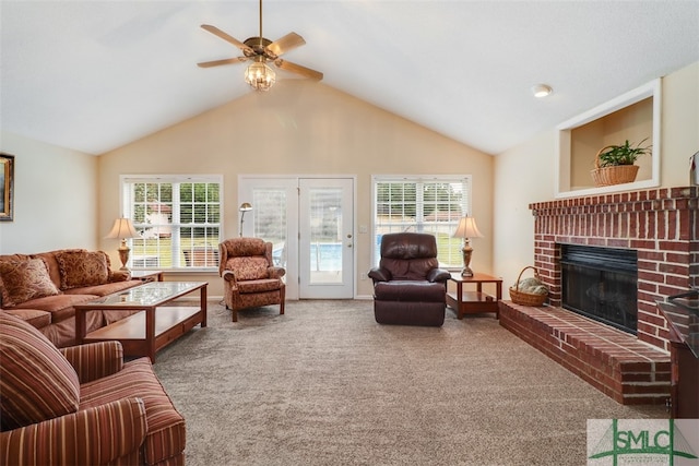 carpeted living room featuring a fireplace, high vaulted ceiling, and ceiling fan