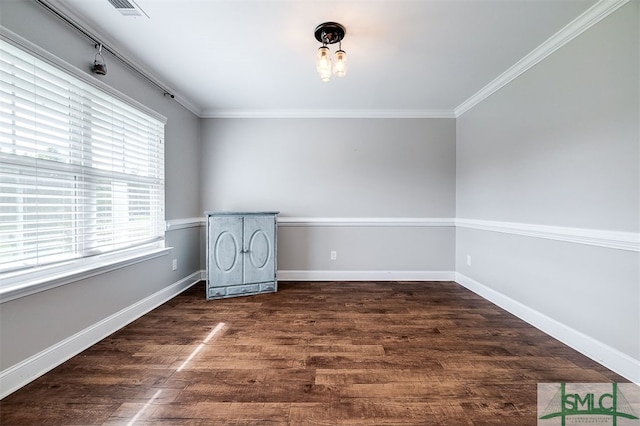 empty room featuring dark hardwood / wood-style floors and crown molding